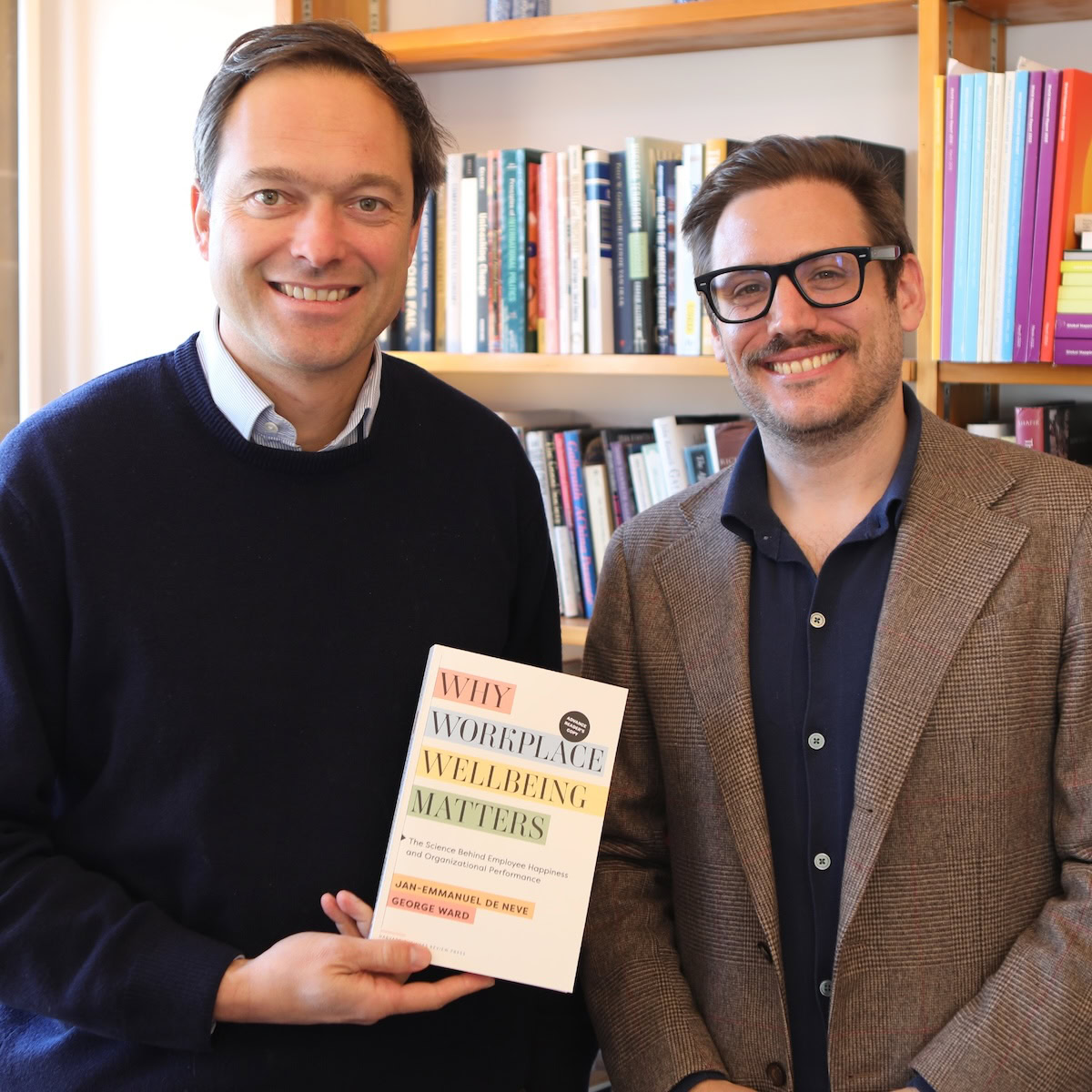 Jan-Emmanuel De Neve and George Ward with the book Why Workplace Wellbeing Matters